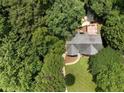 Aerial view showcases a beautiful home nestled amongst lush greenery and a spacious backyard deck at 5020 Bayberry Dr, Cumming, GA 30040