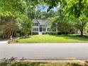 Charming home with a lush front yard and mature trees lining the street at 5020 Bayberry Dr, Cumming, GA 30040
