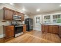 Well-lit kitchen with hardwood floors, updated appliances and wooden cabinets at 724 Bellemeade Nw Ave, Atlanta, GA 30318