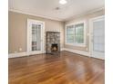 Inviting living room featuring a stone fireplace and gleaming hardwood floors at 724 Bellemeade Nw Ave, Atlanta, GA 30318