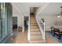 Spacious foyer with staircase and an open view to the dining and living areas, perfect for entertaining at 740 Paris Dr, Lawrenceville, GA 30043