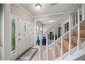 Bright foyer featuring a staircase, hardwood floors, and a view into the adjacent living spaces at 740 Paris Dr, Lawrenceville, GA 30043