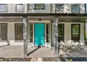 Close-up of a bright aqua front door flanked by sidelights and columns showcasing curb appeal at 8649 Cedar Creek Rdg, Riverdale, GA 30274
