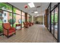 Comfortable seating area in a bright lobby with large windows offering views of the outside gardens at 300 Johnson Ferry Ne Rd # B808, Atlanta, GA 30328