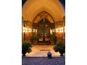 Welcoming portico entrance featuring arched doorway, brick pillars, and decorative outdoor lighting at 114 Lees Lake Rd, Fayetteville, GA 30214