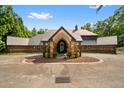 A charming exterior view showcasing a brick home and spacious driveway at 114 Lees Lake Rd, Fayetteville, GA 30214
