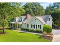 Beautiful one-story home with a classic design, landscaped yard, and inviting covered front porch at 207 Lees Lake Rd, Fayetteville, GA 30214