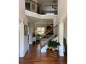 Grand foyer with wood floors, staircase, and detailed trim work creates a welcoming entrance at 4745 Belcrest Way, Cumming, GA 30040