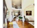 Welcoming foyer with hardwood floors, elegant staircase, and soaring ceilings at 4745 Belcrest Way, Cumming, GA 30040