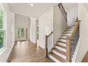 Bright foyer with hardwood floors, staircase and large windows offering natural light at 715 Crest Line Trl, Powder Springs, GA 30127