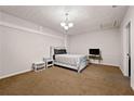 Bedroom with neutral carpet and decor, with a queen bed and a bedside table at 1328 Hidden Hills Pkwy, Stone Mountain, GA 30088