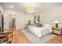 Relaxing main bedroom with decorative wall trim, a plush bed, and warm natural light at 50 Howell Se St # A, Atlanta, GA 30312