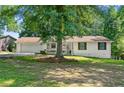 Quaint single-story house featuring a charming front porch and a lush green lawn at 830 The Cir, Lawrenceville, GA 30043