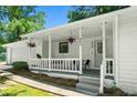 Inviting front porch with seating and hanging plants at 830 The Cir, Lawrenceville, GA 30043