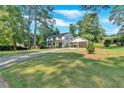 Inviting two-story home with lush lawn and spacious driveway leading to covered parking at 1406 Arden Sw Dr, Marietta, GA 30008