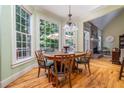Breakfast nook with hardwood floors and large windows overlooking the backyard at 2015 Buford Dam Rd, Buford, GA 30518