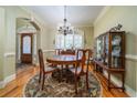 Formal dining room with hardwood floors, decorative chandelier, and beautiful wood accents at 2015 Buford Dam Rd, Buford, GA 30518