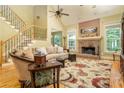 Cozy living room features hardwood floors, a brick fireplace, and lots of natural light at 2015 Buford Dam Rd, Buford, GA 30518