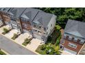 Aerial view of brick townhomes showing landscaped yards, private entrances, and community setting at 3733 Chattahoochee Summit Se Dr # 7, Atlanta, GA 30339
