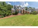 A brick home with a sprawling green lawn and neatly trimmed shrubbery at 501 Highwater Pass, Canton, GA 30114