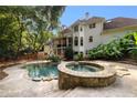 Private backyard oasis with a stone hot tub, in-ground pool, and lush greenery at 510 Northland Ridge Ct, Sandy Springs, GA 30342