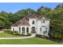 Elegant home boasting manicured lawn, beautiful arched windows, and a welcoming walkway at 510 Northland Ridge Ct, Sandy Springs, GA 30342