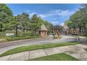 Gated community entrance with manicured landscaping and brick gatehouse at 578 Mcgill Ne Pl # 578, Atlanta, GA 30312