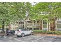 Exterior shot of condos under shade trees; convenient guest parking at 578 Mcgill Ne Pl # 578, Atlanta, GA 30312