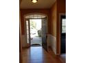 Open foyer features hardwood floors, natural light, and an open front door at 5252 Inverness Ct, Douglasville, GA 30135