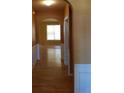 Hallway with hardwood floors and decorative molding leads to a living area with natural light at 5252 Inverness Ct, Douglasville, GA 30135
