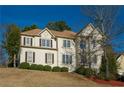 Elegant two-story home showcasing symmetrical windows and a well-maintained lawn, offering timeless appeal at 600 Oakmont Hl, Duluth, GA 30097