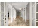 Elegant entrance with hardwood floors, graceful columns, and arched details, providing a warm and inviting atmosphere at 600 Oakmont Hl, Duluth, GA 30097