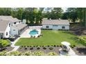 An entertainer's dream backyard with pool, hot tub, pool house, outdoor seating and lush landscaping at 604 Trinity Church Rd, Canton, GA 30115