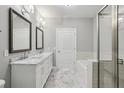 Elegant bathroom with marble floors, dual vanities, and a glass-enclosed shower at 901 Abernathy Rd # 2200, Sandy Springs, GA 30328