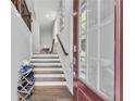 Bright entryway featuring hardwood floors, stairs, and view of a glass paneled front door at 1823 Lynwood Ln, Atlanta, GA 30329