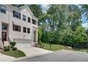 Beautiful townhome featuring white brick and an attached garage with landscaped front yard at 1823 Lynwood Ln, Atlanta, GA 30329
