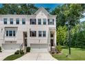 Inviting townhome with brick facade, attached garage, and meticulously maintained landscaping at 1823 Lynwood Ln, Atlanta, GA 30329