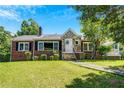 Beautiful brick home with a stone facade, front lawn, and covered porch, exuding classic charm at 1544 Brewer Sw Blvd, Atlanta, GA 30310