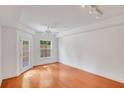 Bright bedroom with hardwood floors, ceiling fan, and access to a balcony at 230 E Ponce De Leon Ave # 116, Decatur, GA 30030