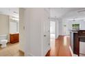 Bright condo entryway with hardwood floors leading to the bathroom, kitchen and living area at 230 E Ponce De Leon Ave # 116, Decatur, GA 30030