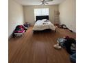 Bright bedroom with a window, hardwood floors, and a simple bed setup at 2390 Coach Way, Jonesboro, GA 30236
