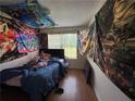 Unique bedroom with creative wall decor and a comfortable bed near a bright window at 2390 Coach Way, Jonesboro, GA 30236