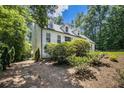 A charming two-story home surrounded by lush greenery and mature trees at 186 Fernleaf Lane Ln, Marietta, GA 30068