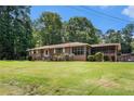 A ranch home with well-maintained front yard and a screened porch, creating a welcoming curb appeal at 2247 Cypress Ave, Morrow, GA 30260