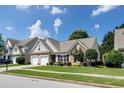 Charming single Gathering home with a well-manicured lawn and a two-car garage at 2423 Walnut Tree Ln, Buford, GA 30519