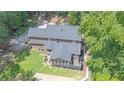 Aerial view of a home showcasing a screened-in porch, back deck and large backyard with swimming pool at 10560 Haynes Bridge Rd, Alpharetta, GA 30022