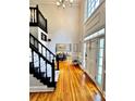 Bright foyer with high ceilings, hardwood floors, and elegant staircase with dark banister at 10560 Haynes Bridge Rd, Alpharetta, GA 30022