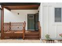 Stylish craftsman style front door with black accents and a charming wood porch at 2328 Lakewood Sw Ave, Atlanta, GA 30315