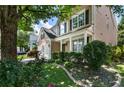 Beautiful home featuring a covered porch, meticulously landscaped yard, and charming curb appeal at 424 Citronelle Dr, Woodstock, GA 30188