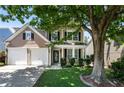 Inviting home with a well-manicured lawn, a two-car garage, and a classic architectural style at 424 Citronelle Dr, Woodstock, GA 30188
